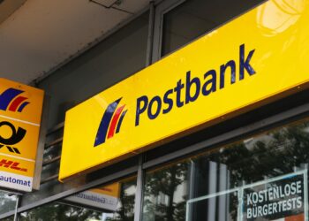 Postbank-Filiale mit wartenden Business-Kunden, die Beschwerdeformulare ausfüllen und einreichen